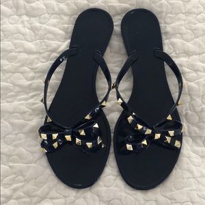 Navy blue jelly studded flip flops bow